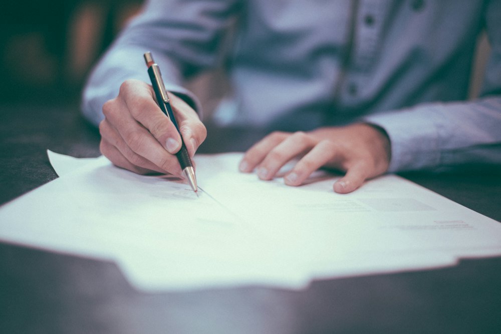 Signing a document at a desk